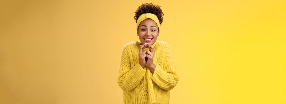 Thrilled cute charming african-american smiling girl. cross fingers good luck press hands together grinning look hopefully camera praying good luck dream come true believe receive positive news.