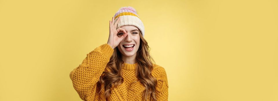 Carefree playful charismatic charming caucasian woman winter vacation having fun show okay ok gesture look through circle happily laughing smiling broadly white teeth, enjoying travel mountrains.