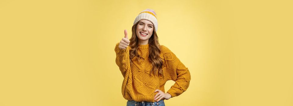 Lucky good-looking friendly supportive girlfriend congratulating you nice work good job show thumb-up gesture satisfied liking awesome product recommend promotion, smiling yellow background.