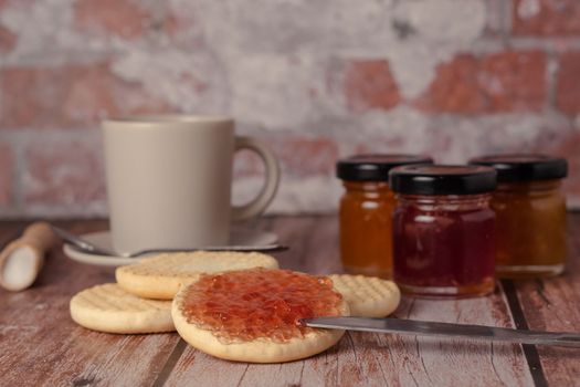 cookies with jam and coffee cup on a wooden table