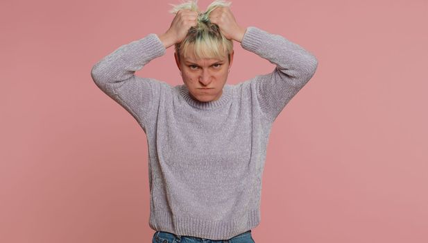 Dissatisfied woman with short hair asking reason of failure, expressing disbelief irritation, feeling bored, disappointed in result, bad news. Young girl on pink background. Lgbt gay lesbian people
