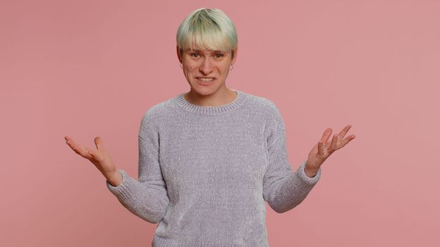 What Why. Sincere irritated woman raising hands in indignant expression asking reason of failure demonstrating disbelief irritation by troubles. Confused one girl on pink background. Lgbt gay lesbian