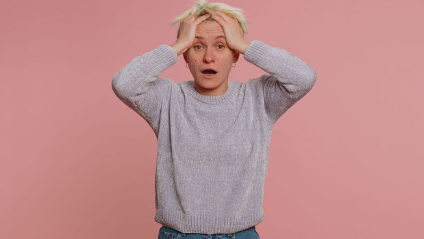 Stressed depressed woman terrified about danger problems, suffering phobia, anxiety disorder, expresses fear, waving no, insecure, stress, panic. Young girl on pink background. Lgbt gay lesbian people