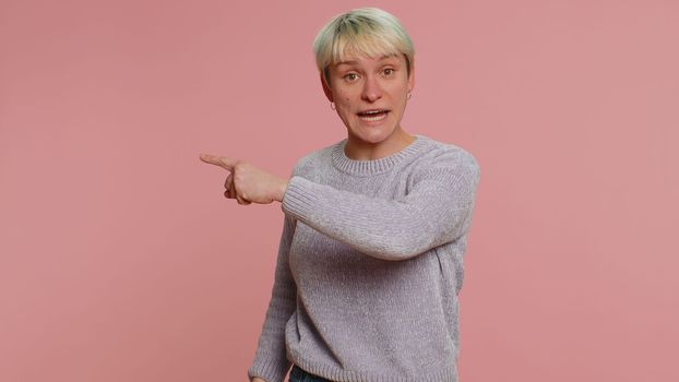 Get out of here. You are fired. Woman with short green hair pointing finger away asking to leave her alone, strict boss firing conflict. Young girl isolated on pink background. Lgbt gay lesbian people