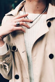 Close-up portrait Beautiful elegant woman wearing beige coat and black hat. Trendy casual outfit. Soft selective focus. grain.