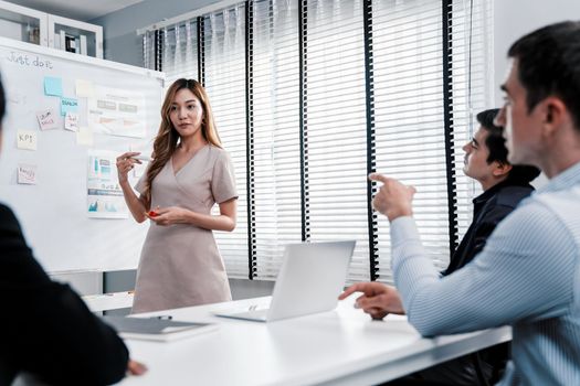 Competent office workers from various nationalities are debating, discussing and brainstorming in the meeting room. A group of employees is collaborating to achieve their business objectives.