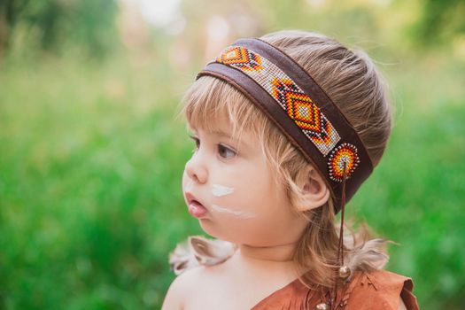 Cute baby dressed in traditional Native American costume.