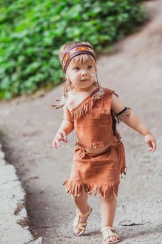Cute baby dressed in traditional Native American costume.