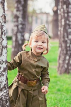 Adorable baby girl in Soviet military uniform.