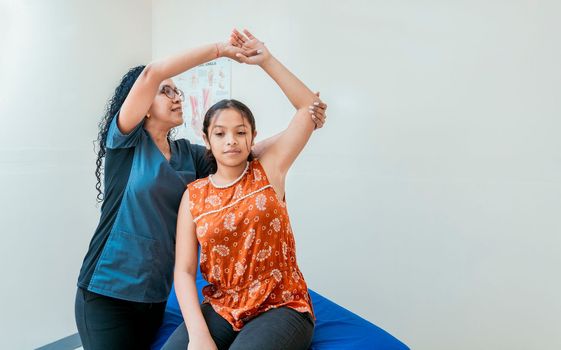 Young physiotherapist with patient rehabilitating shoulder and elbow, Physiotherapist with female patient rehabilitating elbow. elbow and shoulder rehabilitation physiotherapy