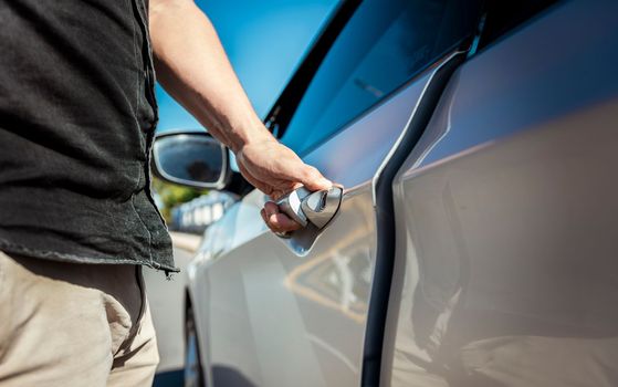 Hands opening the car door. Close-up of male hand opening car door. Vehicle owner opening the door with the keys. car rental concept