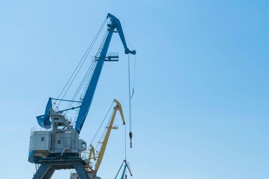 port cranes not working against the blue sky. photo