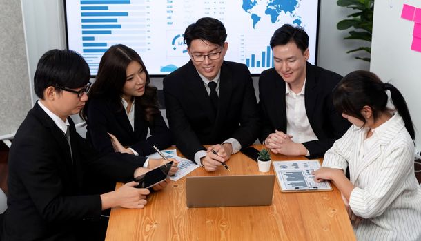 Business team of financial data analysis meeting with business intelligence, report paper and dashboard on laptop for marketing strategy. Business people working together to promote harmony in office.