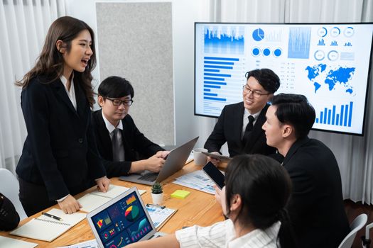 Business team of financial data analysis meeting with business intelligence, report paper and dashboard on laptop for marketing strategy. Business people working together to promote harmony in office.