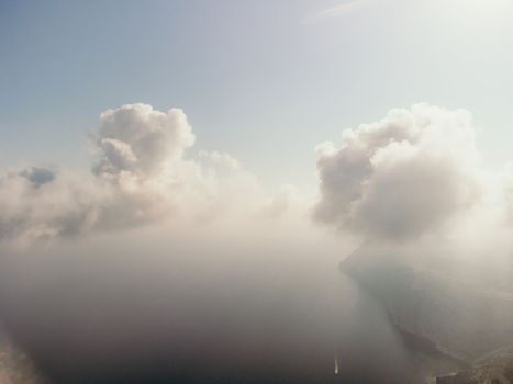 Blue sky with white clouds moving panorama summer. Sea in light of day aerial view of drone slide forward. Small waves on sea. Sunny sunset over the sea. Sun way. Horizon