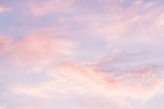 Blue sky background with white and pink clouds at sunset. High quality photo