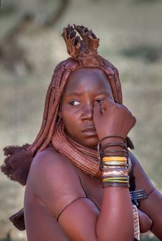 May 15, 2005. portrait of unidentified Himba woman  with the traditional hairstyle, necklace and the typical ochre tinted skin. Epupa Falls, Kaokoland or Kunene Province, Namibia, Africa