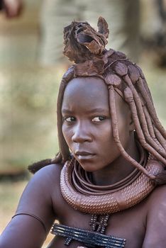May 15, 2005. portrait of unidentified Himba woman with the traditional hairstyle, necklace and the typical ochre tinted skin. Epupa Falls, Kaokoland or Kunene Province, Namibia, Africa