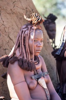 May 15, 2005. portrait of unidentified Himba woman  with the traditional hairstyle, necklace and the typical ochre tinted skin. Epupa Falls, Kaokoland or Kunene Province, Namibia, Africa