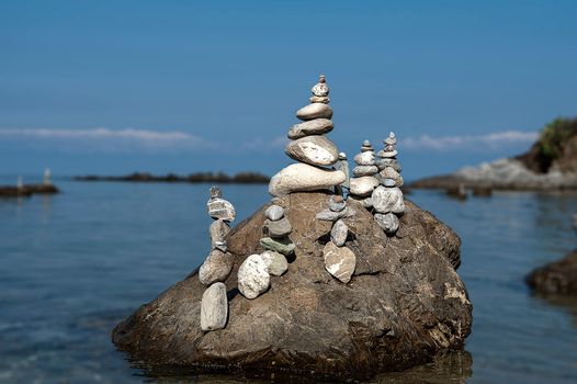 balanced stones on the rocks of the sea