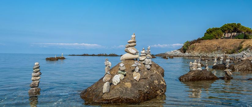 balanced stones on the rocks of the sea