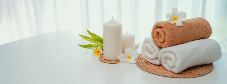 Spa accessory composition set in day spa hotel , beauty wellness center . Spa product are placed in luxury spa resort room , ready for massage therapy from professional service .