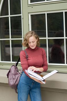 young caucasian girl going back to college, standing with a backpack and notebooks and smiling, back to school, High quality photo