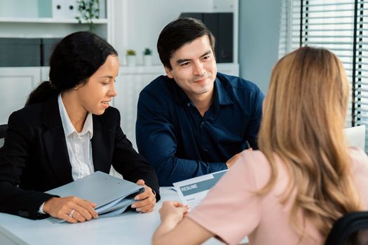 A young female asian candidate tries to impress her interviewer by being competent. International company, multicultural environment in workplace.