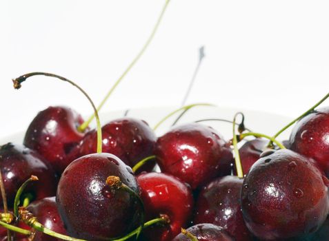 Cherry in a bowl on a white background.