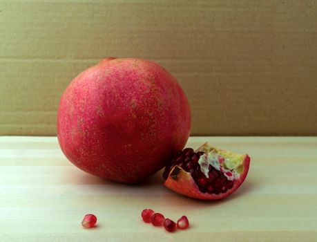 Pomegranate, photo. Photo of a pomegranate on a wooden table.