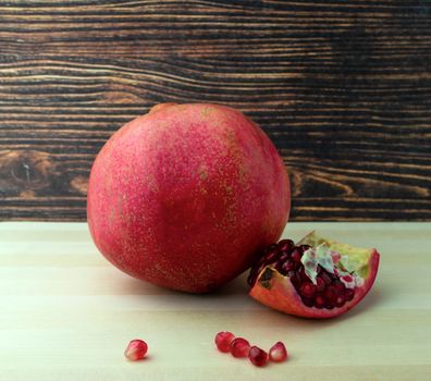 Pomegranate, photo. Photo of a pomegranate on a wooden table.