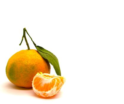 Tangerine with leaves and a slice of tangerine. Tangerine with leaves and a slice of tangerine on a white background,