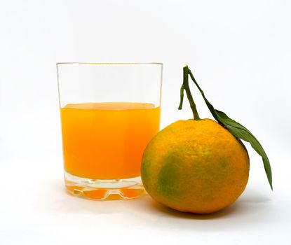 Tangerine and tangerine juice. Tangerine and tangerine juice on a white background, close-up.