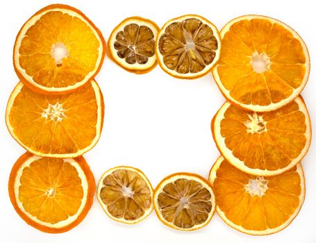 Slices of dried orange and lemon, background. Slices of dried orange and lemon on a white background, close-up.
