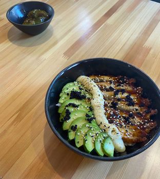 Rice with eel. In the photo, a dish in a restaurant: rice with eel and avocado.