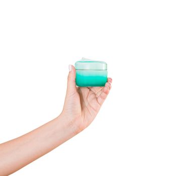 Female hand holding cream bottle of lotion isolated. Girl give cosmetic products on white background.