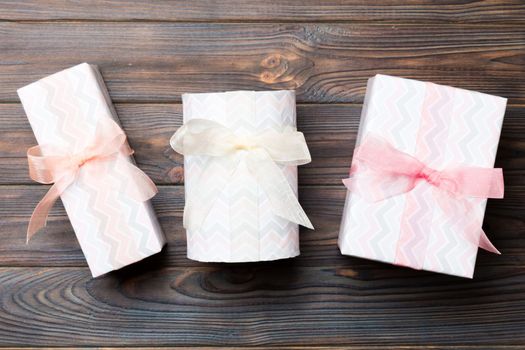 Top view of christmas or other holiday handmade present box package, flat lay dark wooden background with copy space. new year gift box.