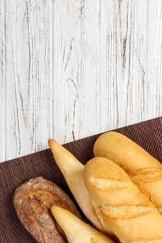 Assortment of fresh French baguettes on a wooden table.