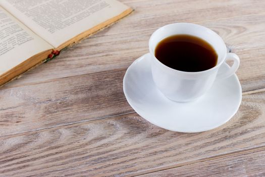 Cup of coffee on a wooden table.