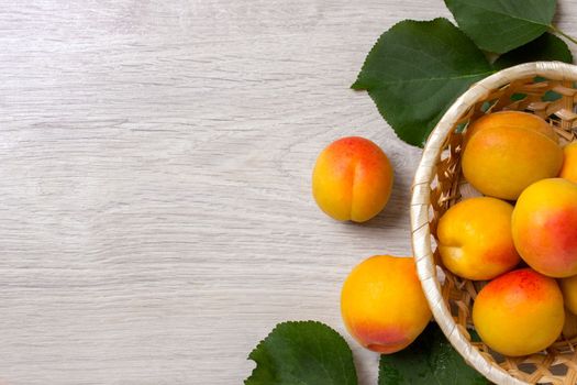 Fresh apricots in the basket On a wooden table