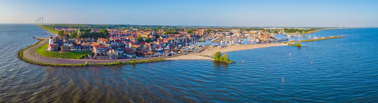 Urk Flevoland Netherlands sunset at the lighthouse and harbor of Urk Holland. Fishing village Urk. Beautiful sunset during the evening