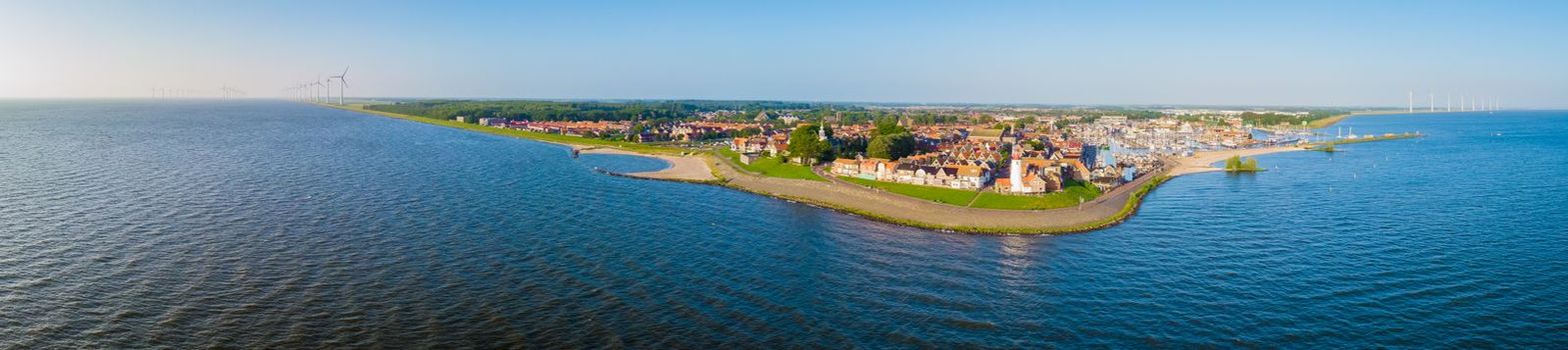 Urk Flevoland Netherlands sunset at the lighthouse and harbor of Urk Holland. Fishing village Urk. Beautiful sunset during the evening