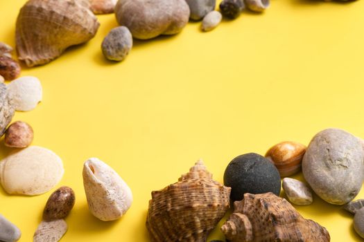rocks and shells on a yellow background .Marine theme.