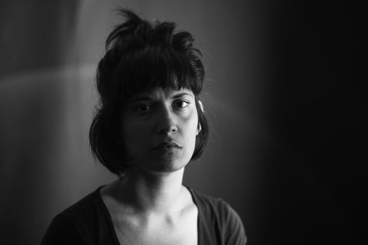 Dramatic portrait of an indian girl on black background