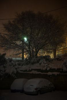 Car covered by snow in the nigh. Sicily