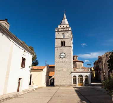 View of the bell tower of the ancient Church of the Assumption of the Blessed Virgin Mary in Omisalj, Croatia