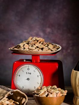 Composition with dried broad beans and weight scale in a wooden table