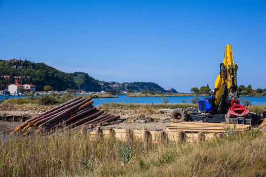 Big powerful excavator digging drainage channel in swamp, Strunjan. Slovenia