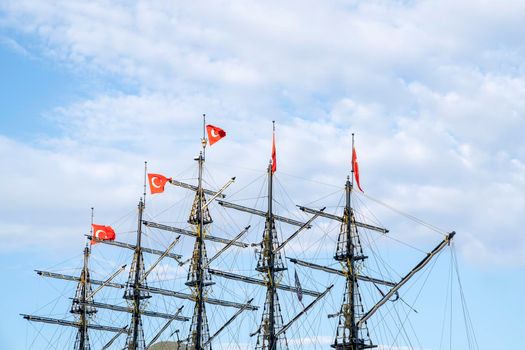 Masts of the ship with turkish flags on the background of the blue sky. The concept of travel and freedom. Copy space