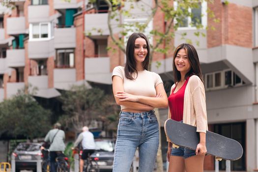 two young women posing happy and smiling looking at camera, concept of female friendship and teenager lifestyle, copy space for text